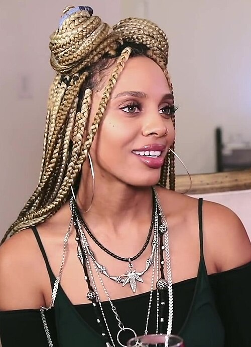 Blonde box braids in a half-up bun style