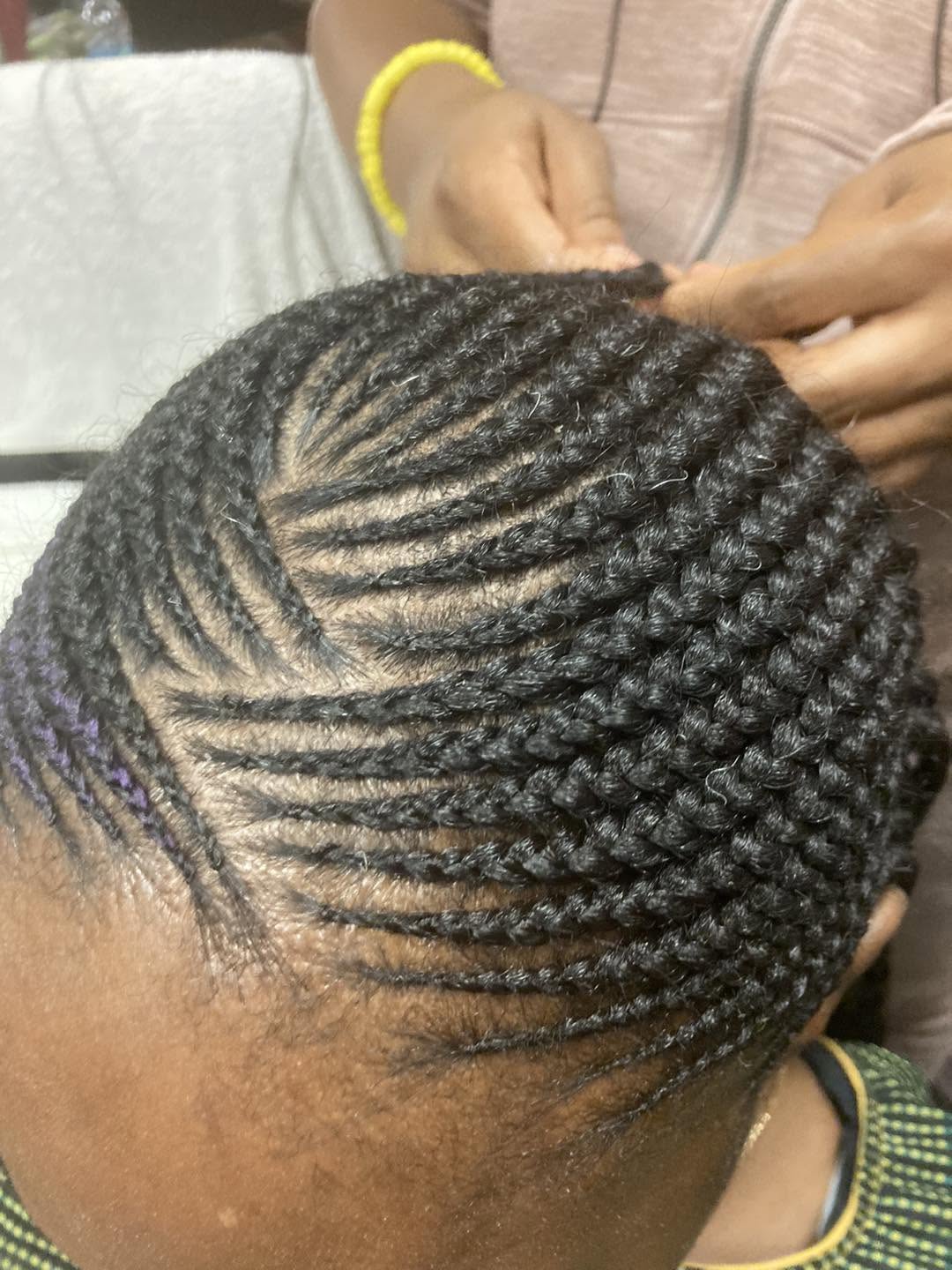 Cornrows being braided close to the scalp